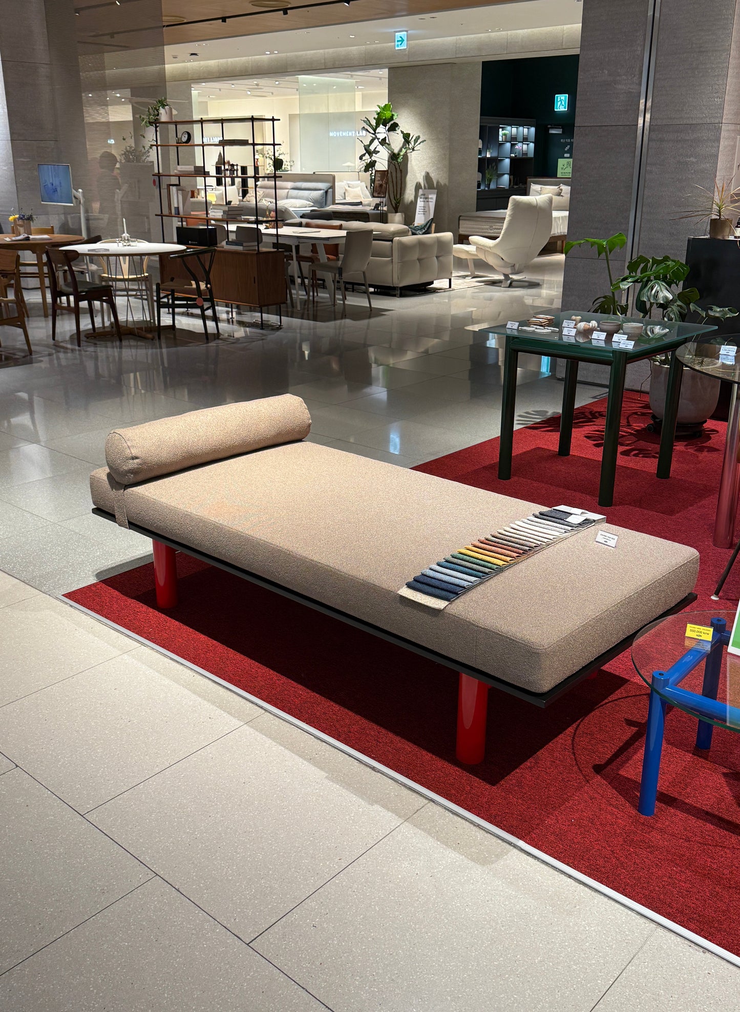 Beige sofa in a showroom with a red carpet